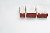 Three types of dries meat on white background, Switzerland
