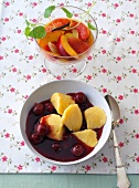 Cherry soup and fruits with orange syrup in bowl