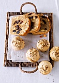 Caraway buns with almond and plum bread on wicker tray 
