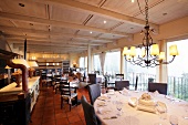Tables laid in dining room of Stazione Da Agnese restaurant, Ticino, Switzerland