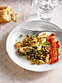 Lentil salad with black roots and nuts on plate for winter