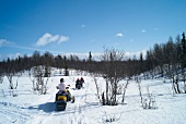 People riding snow mobile on snow at Hemsedal ski resort in Norway