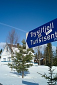 Signboard and white painted traditional wooden house at Trysil ski resort, Norway