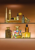 Perfume, nail polish and other beauty products in golden coloured bottle on shelves