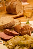 Close-up of sausages, steak, rice and bread on plate