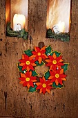 Close-up of felt wreath hanging on wooden surface