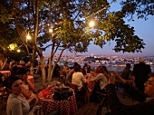 People sitting at restaurant in Bosphorus, overlooking city, Istanbul, Turkey
