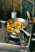 Fried potatoes in a pan on the hob