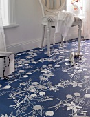 Close-up of blue leaf motif floor with chair on side