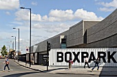 People passing across pop-up mall, Shoreditch, London, UK