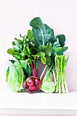 An arrangement of vegetables featuring beetroot, asparagus, pointed cabbage and kohlrabi