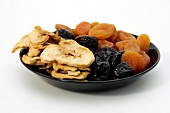 Dried fruits in plate on white background