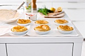 Preparation of baked puff pastry tart with salmon on table