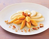 Sweet potato with pears and roasted almonds on plate