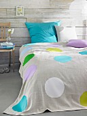 Bed with polka-dot, linen bedspread