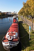 View of theatre ship in river Saar with Berliner Promenade, Saarbrucken, Saarland, Germany
