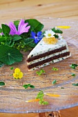 Cake of smoked whitefish fillet with flowers wild herb salad on glass plate