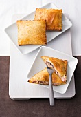 Baked pastry bags with ham on square plates