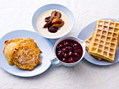 Gluten free pancakes, waffles and mash in bowls and plates