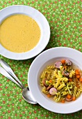 Lentil soup and pasta with sausage and vegetable soup in bowls