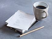 Pencil, shopping list and coffee