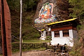 View of rock with Buddha painting and meditation house in Thimpu, Bhutan