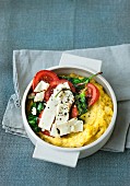 Gratinated polenta with spinach, tomatoes and feta cheese