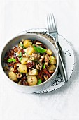 Fried potatoes with dried tomatoes and nuts