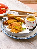 Stuffed courgette flowers with mayonnaise in baking dish