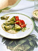 Artichokes with tomato and mayo on plate