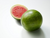 Whole and halved watermelon on white background