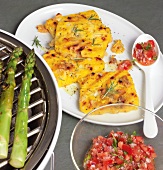 Barbecue polenta slices with cheese, tomato salad on plate