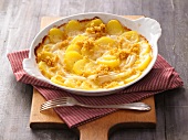 Potato and pear gratin in serving dish