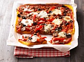 Polenta pizza on baking paper