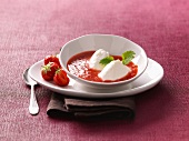 Bowl of quark dumplings with strawberry-kiwi sauce and strawberries