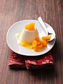 Iced yogurt with mandarin sauce on plate