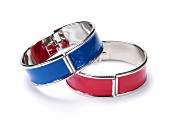 Close-up of red and blue bracelets on white background