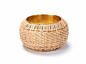 Close-up of wicker on gold bangle