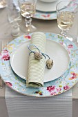 A place setting decorated with a rolled napkin and quail's eggs