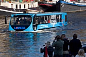 People travelling in floating bus in Oudeschans, Amsterdam, Netherlands