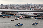 Cityscape of view of city and ferry boats at central station in IJ, Noord, Amsterdam