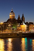 View of St. Nicholas and Schreierstoren at night, Amsterdam, Netherlands