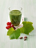 Glass of green smoothie for successful anti-aging