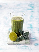 Glass of green smoothie for pure and beautiful skin