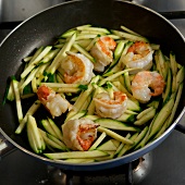 Close-up of shrimps and zucchini in pan, step 3