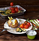 Grilled vegetables and baked potatoes on plate with dip