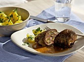 Beef roulades with parsley potatoes on plate