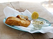 Fried fish with tartar sauce on plate
