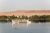 View of Cruise ship on river Nile overlooking mountains, Egypt