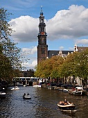 View of Westerkerk church and boats in Prinsengracht canal, Amsterdam, Netherlands